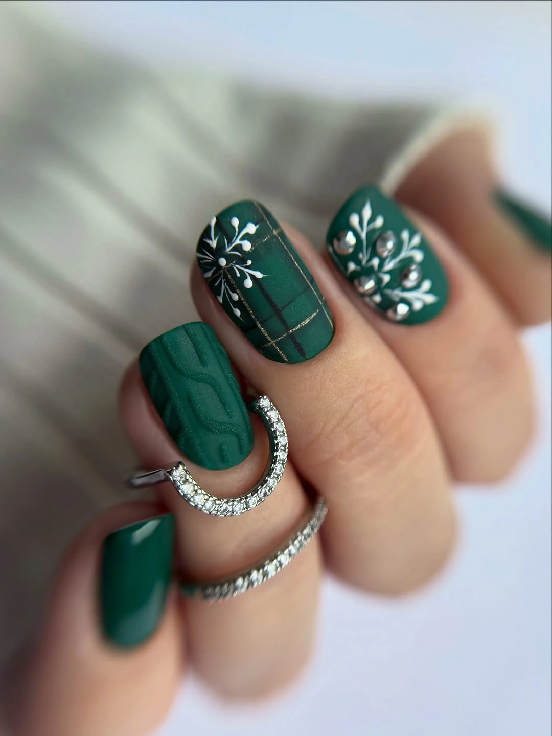 Short green square nails with cable texture and gold plaid