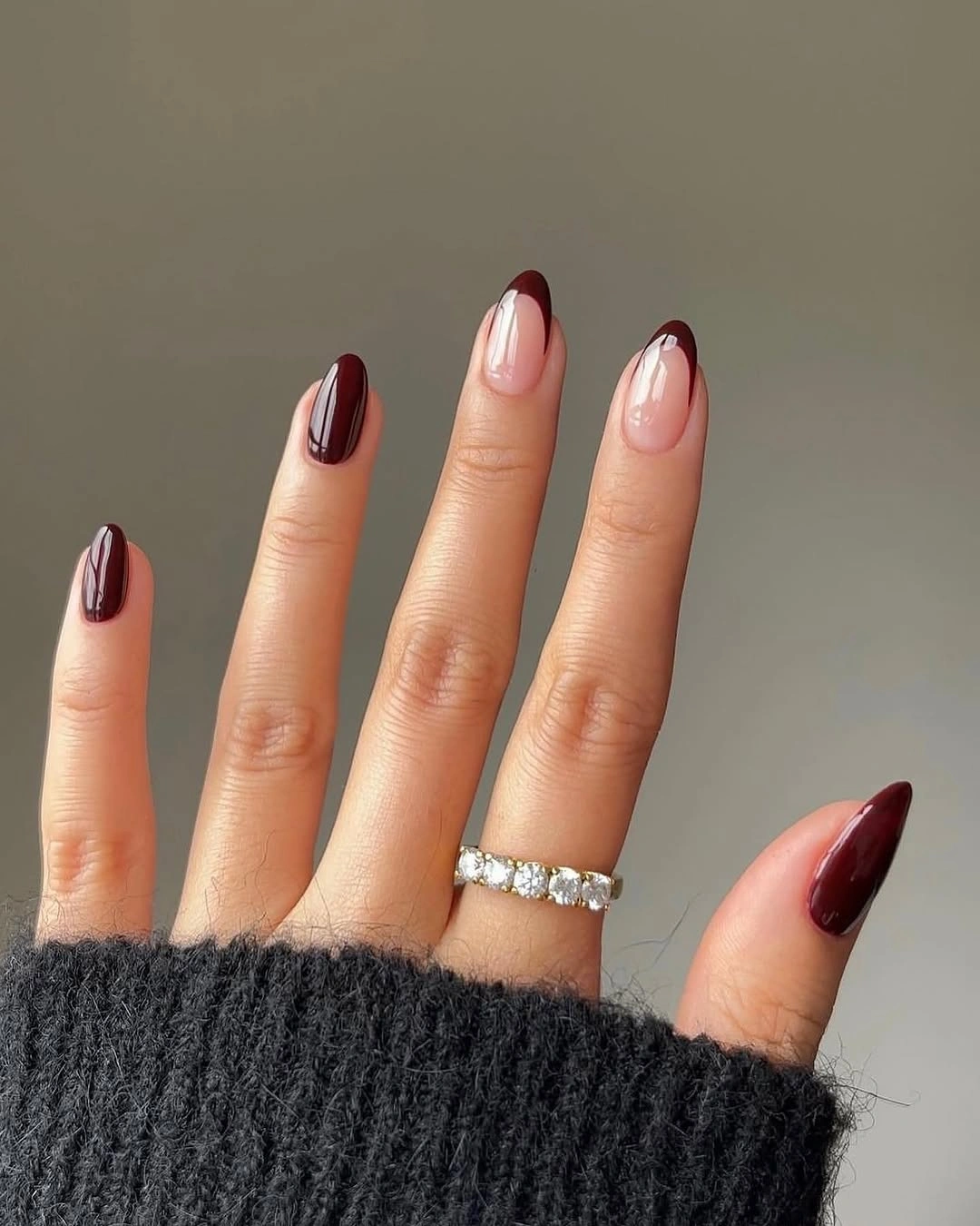 Short almond nails with burgundy polish and nude space