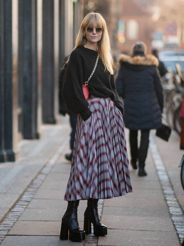 Black blazer with floor-length textured skirt and semi-transparent-looking panels