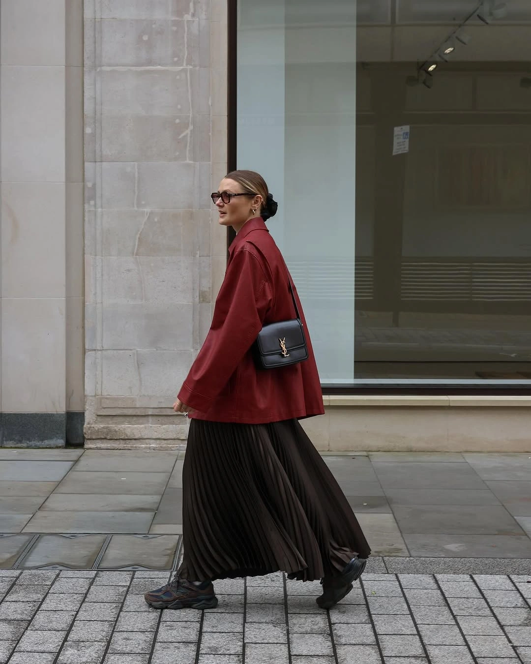 Light gray sweater with lustrous black midi skirt and pointed boots