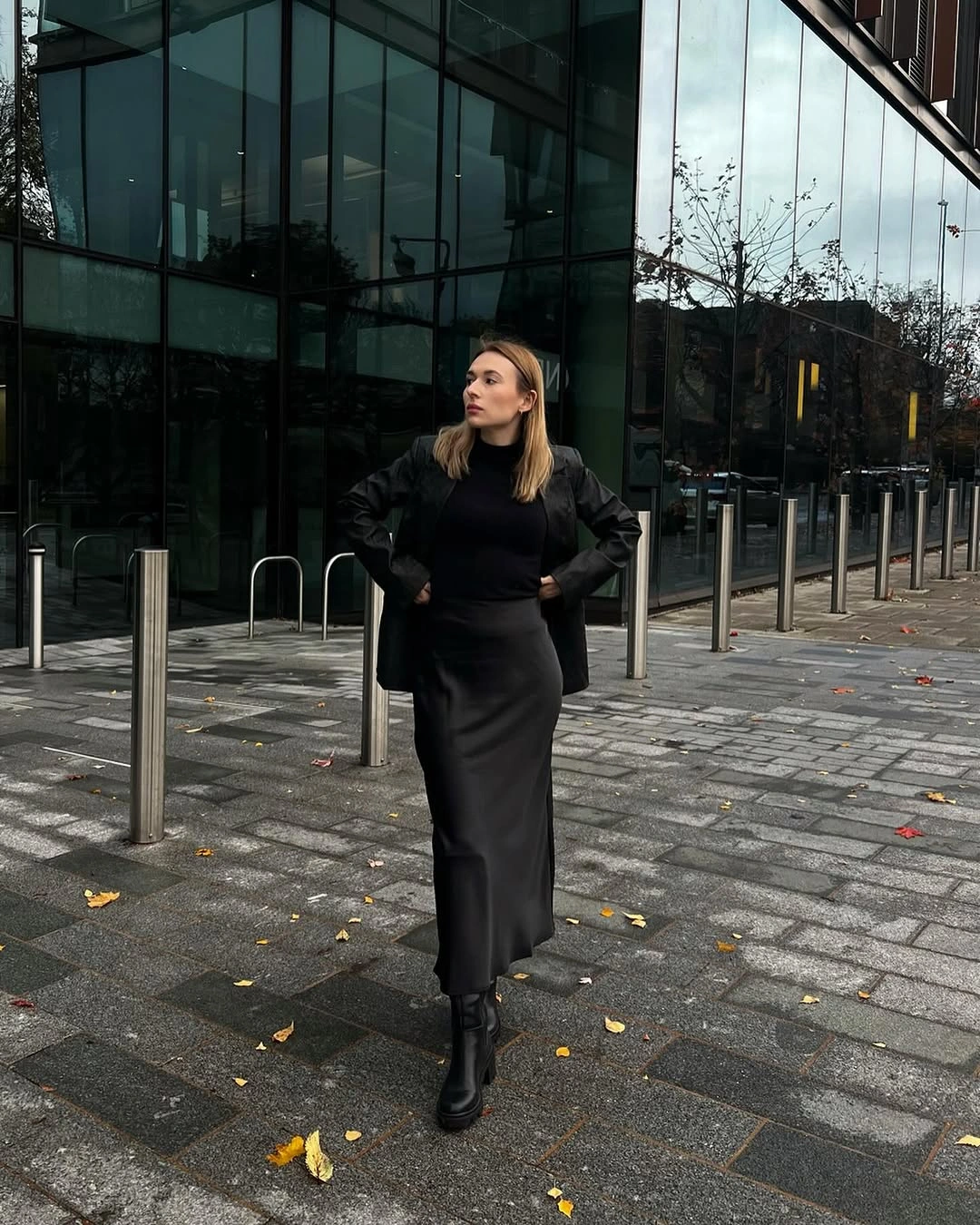 Dark gray turtleneck with asymmetric plaid skirt and chunky black shoes