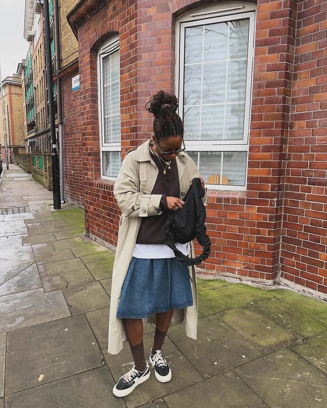 Brown turtleneck with full black ankle-length skirt and black boots
